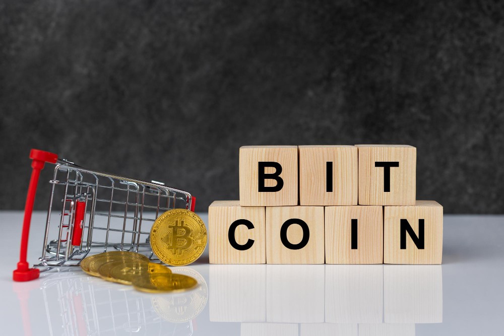 Bitcoin in shopping trolley and wooden blocks