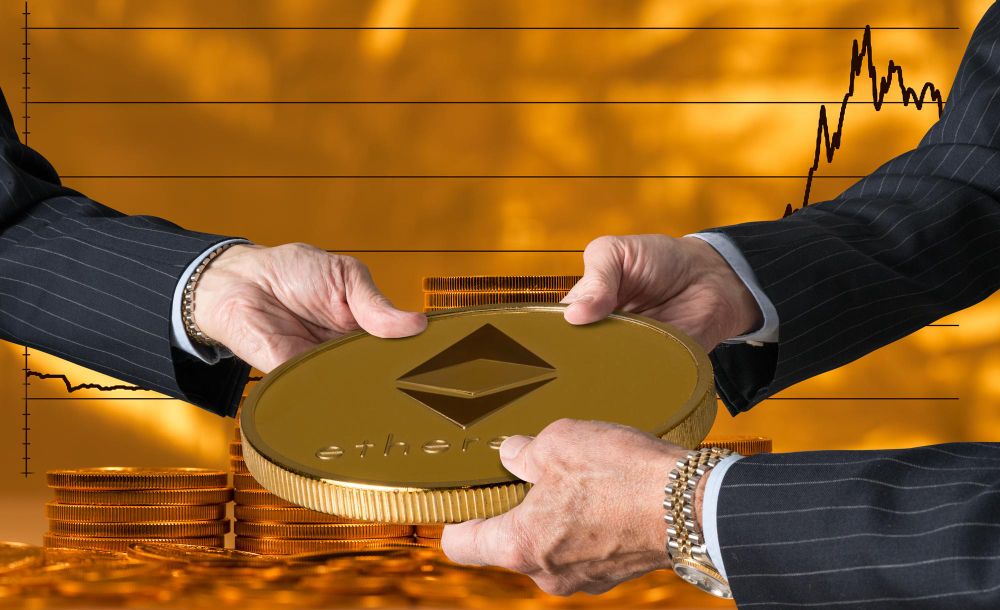 Traders hands holding large ethereum coin